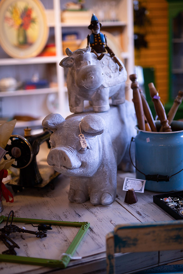 A sculpted cow stacked on a pig